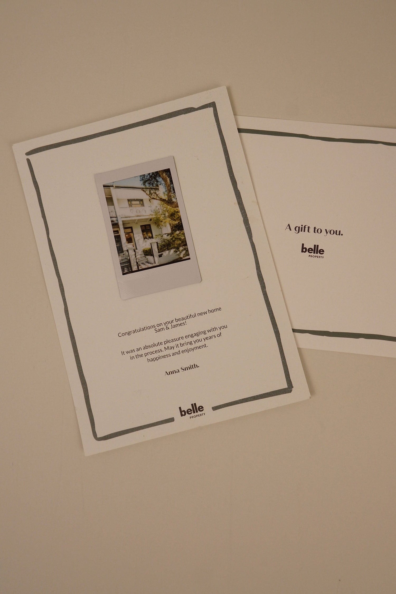 Two greeting cards with 'belle' branding on a beige background