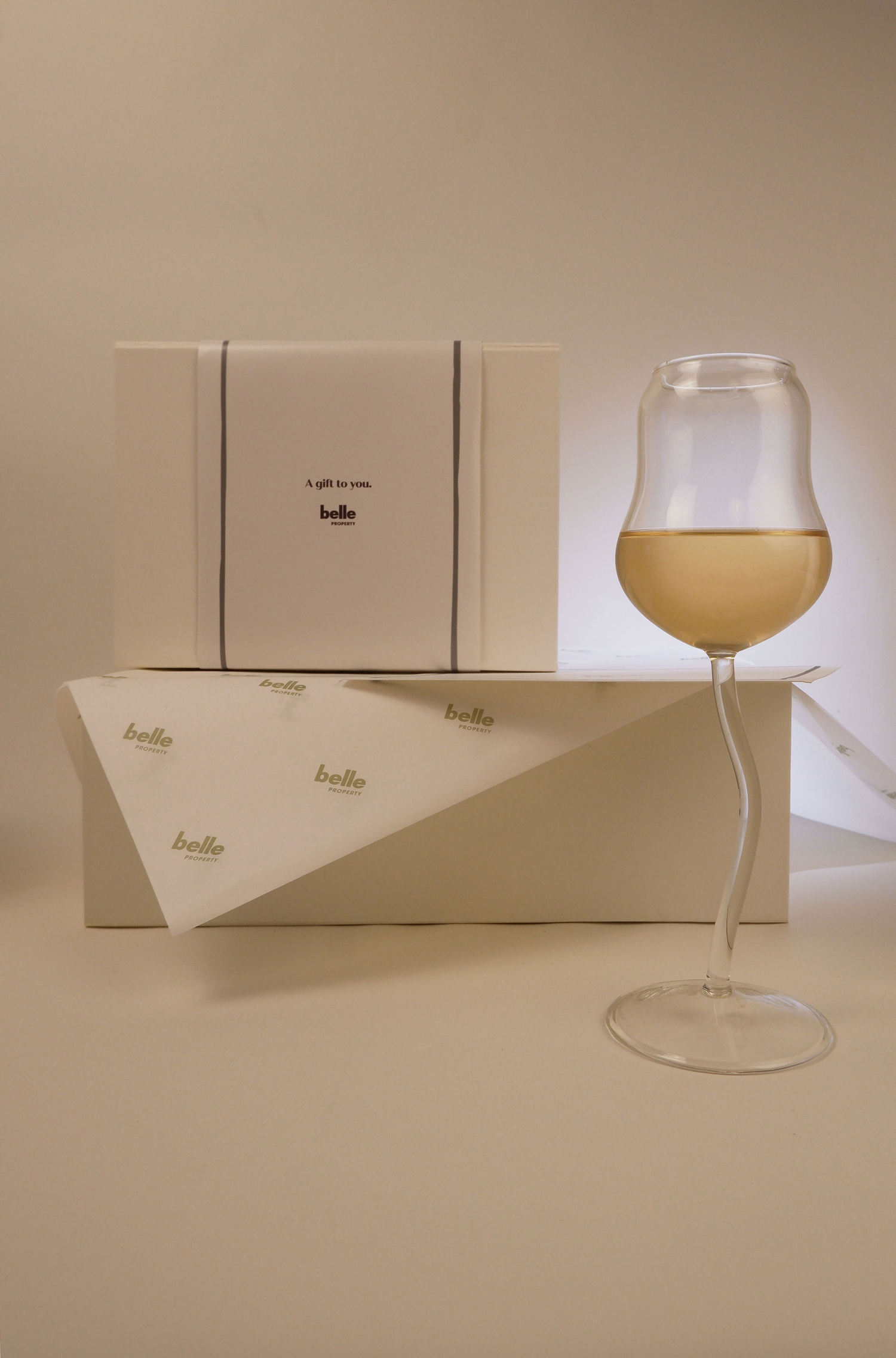 Wine glass with a box on a beige background