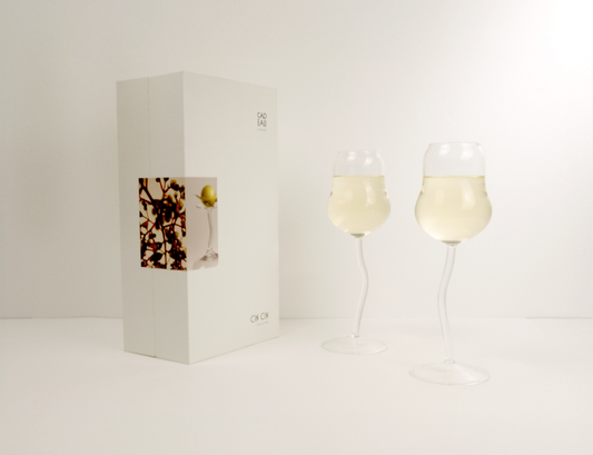Two wine glasses with a bottle of wine on a white background