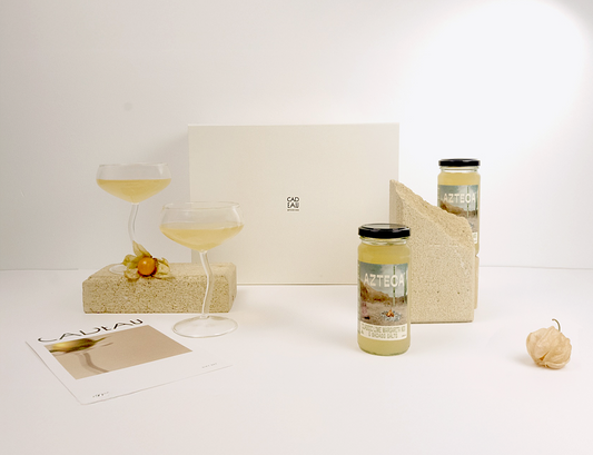 Two jars with labels on a white surface with a light gray background