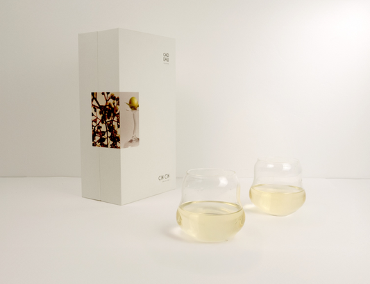 Two glass containers with a small box on a white background