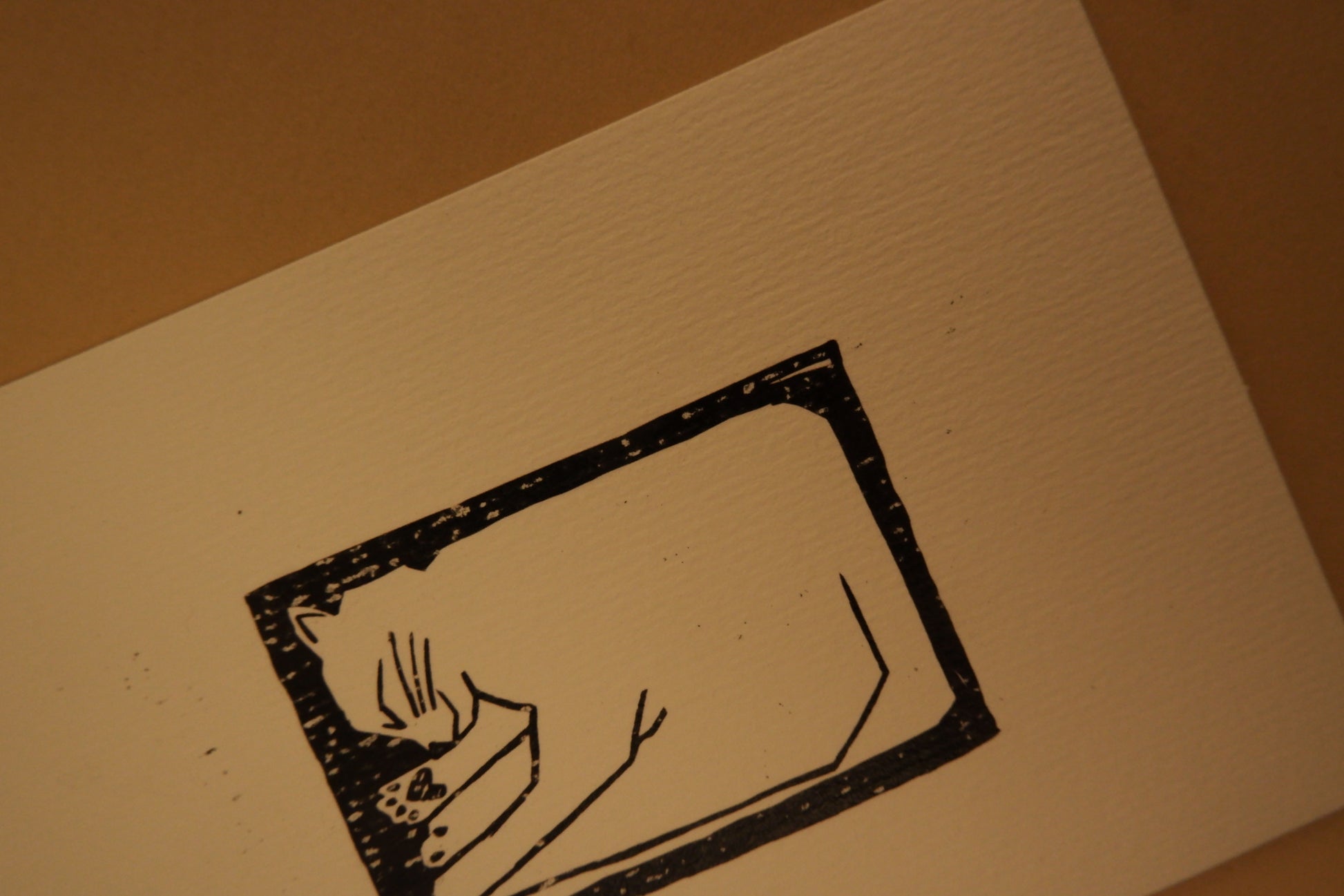 Black ink on beige paper with a brown background