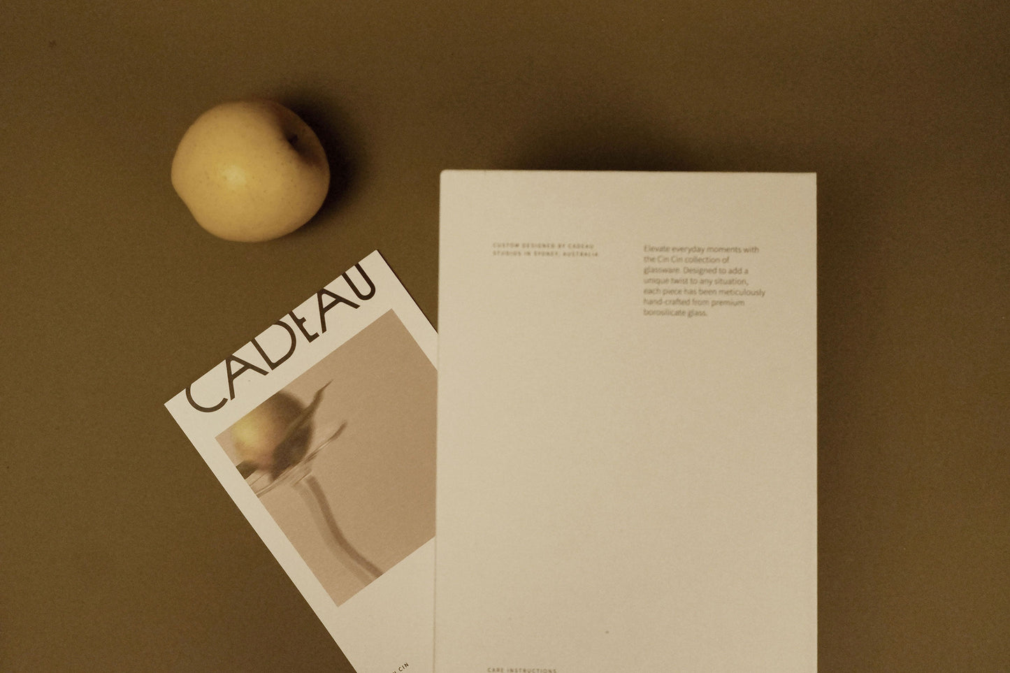 Gift box with an apple on a green background