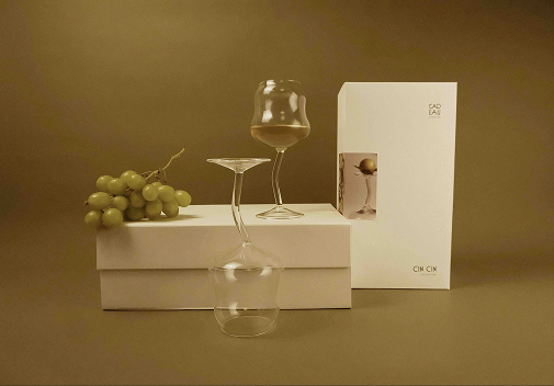 Wine glass, grapes, and a box on a brown background
