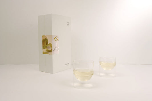 White wine in two tumbler glass on a white background