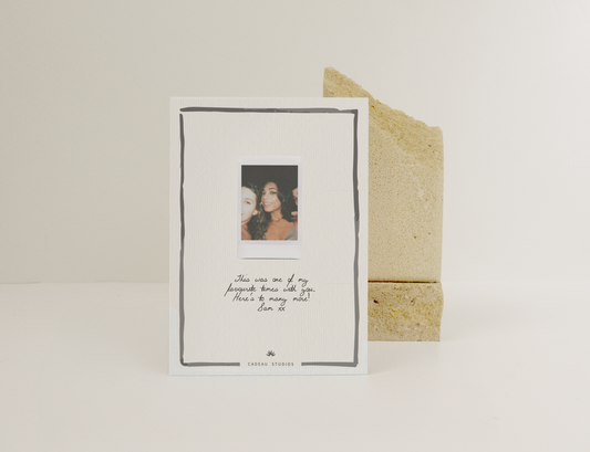 Polaroid on a white card with printed text