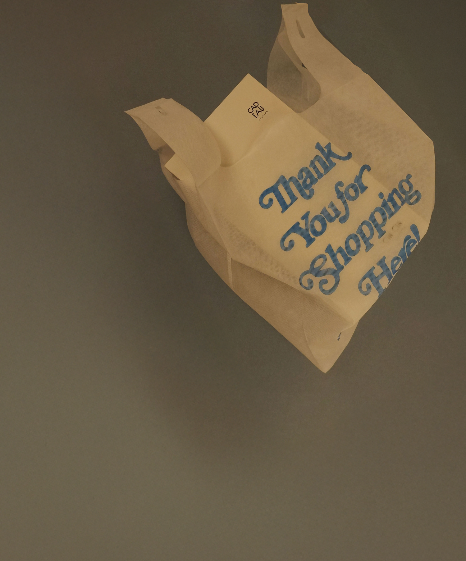 Yellow shopping bag with 'Thank You for Shopping Here!' text on a dark background