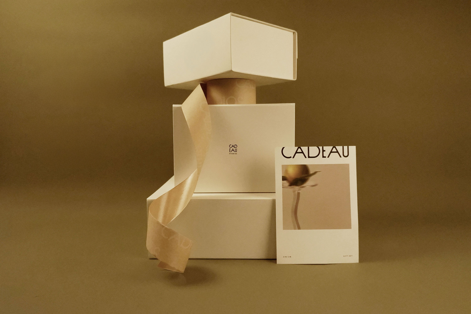 Gift box with a ribbon and a card on a brown background