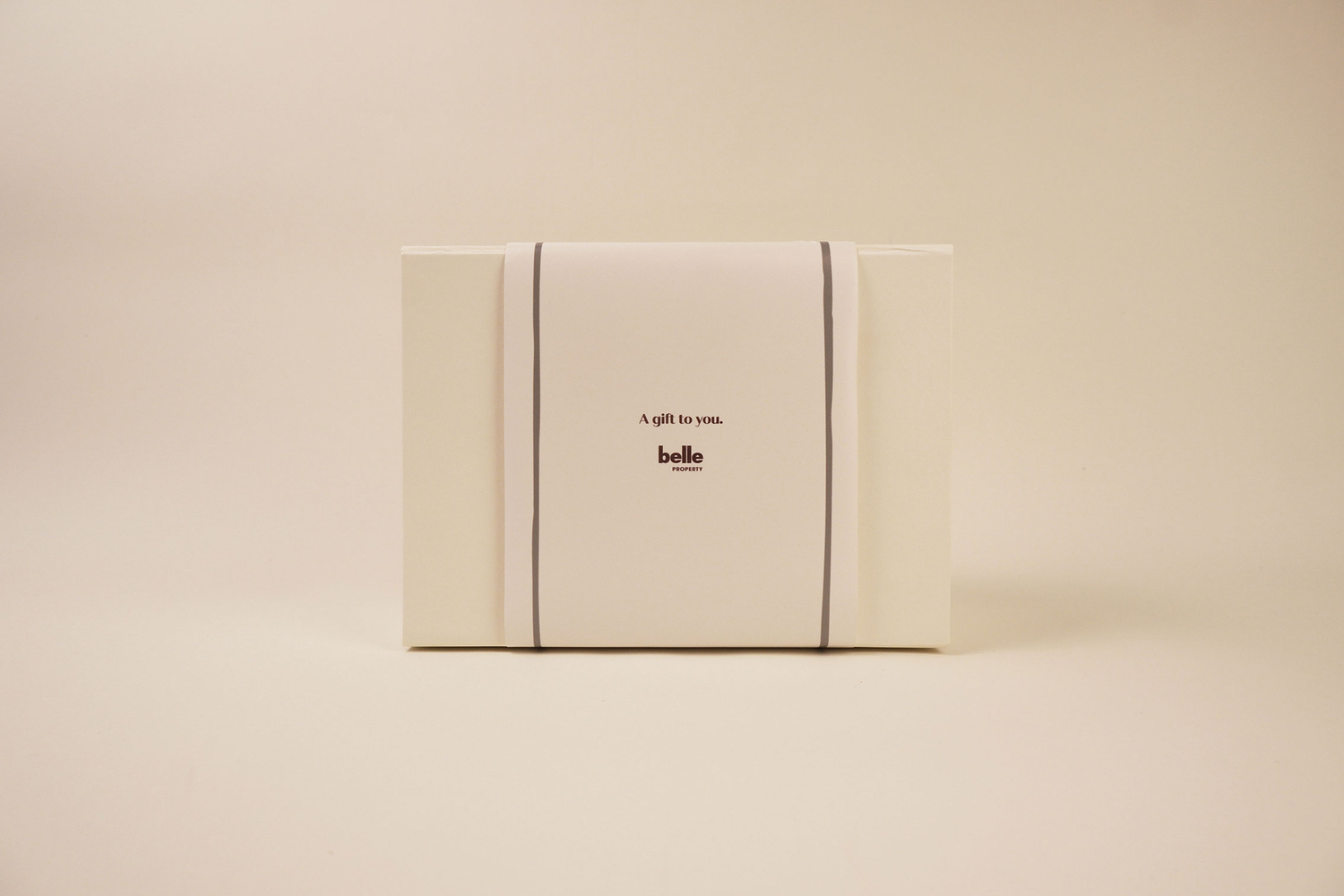 Gift box with 'belle' branding on a beige background
