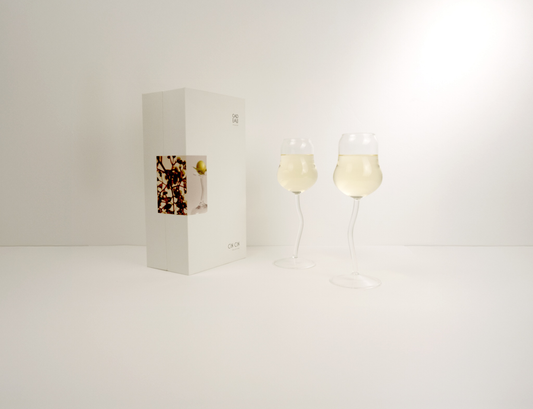 Two wine glasses with a bottle of wine on a white background