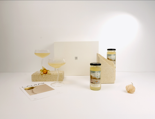 Two jars with labels on a white surface with a light gray background