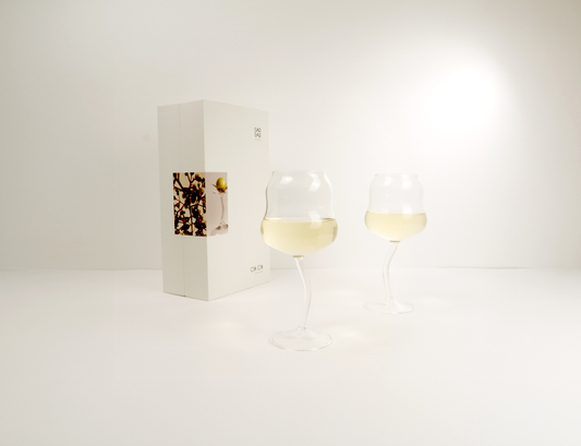 Two wine glasses with white wine on a white background