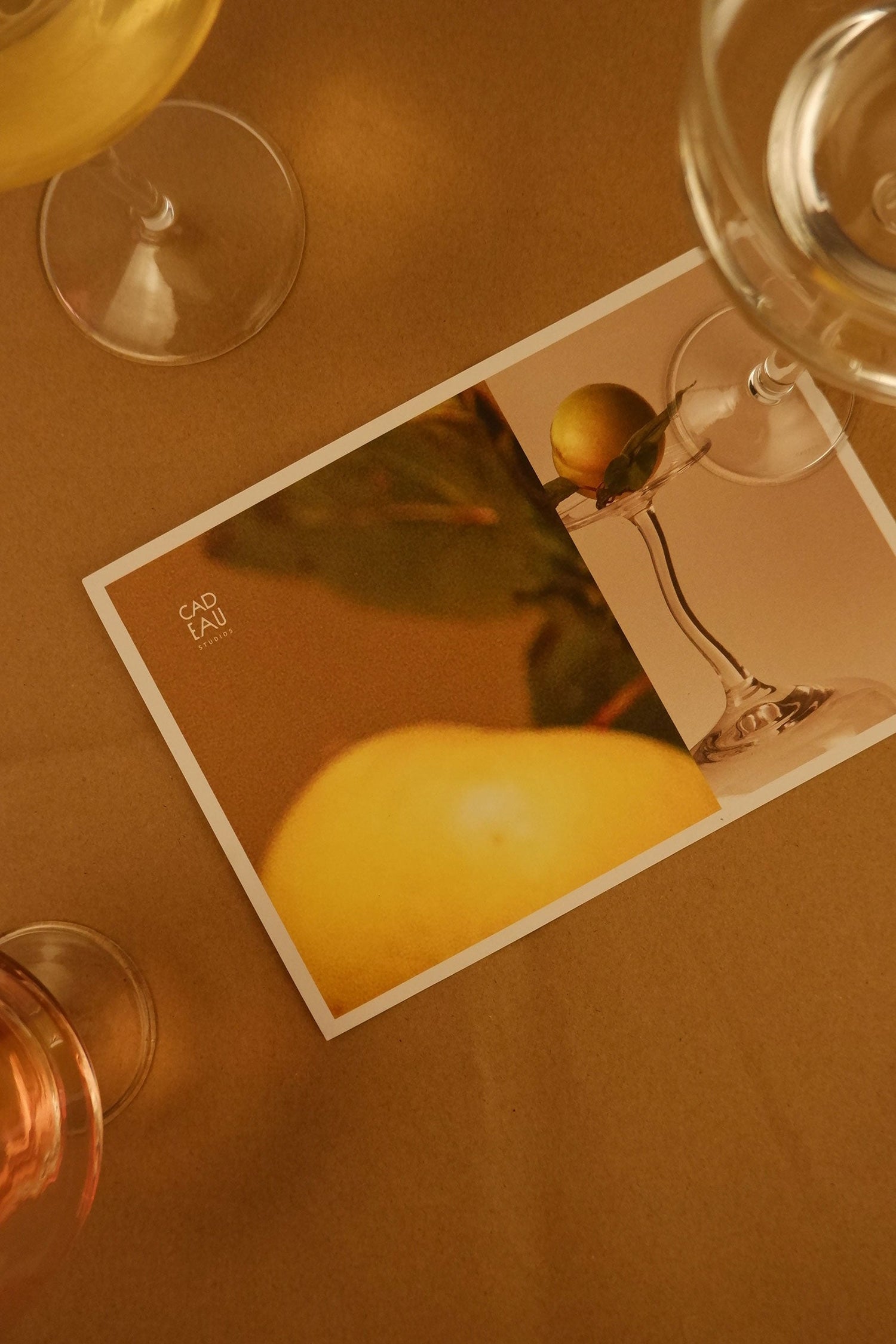 Close-up of a card with a pear and wine glass on a brown surface