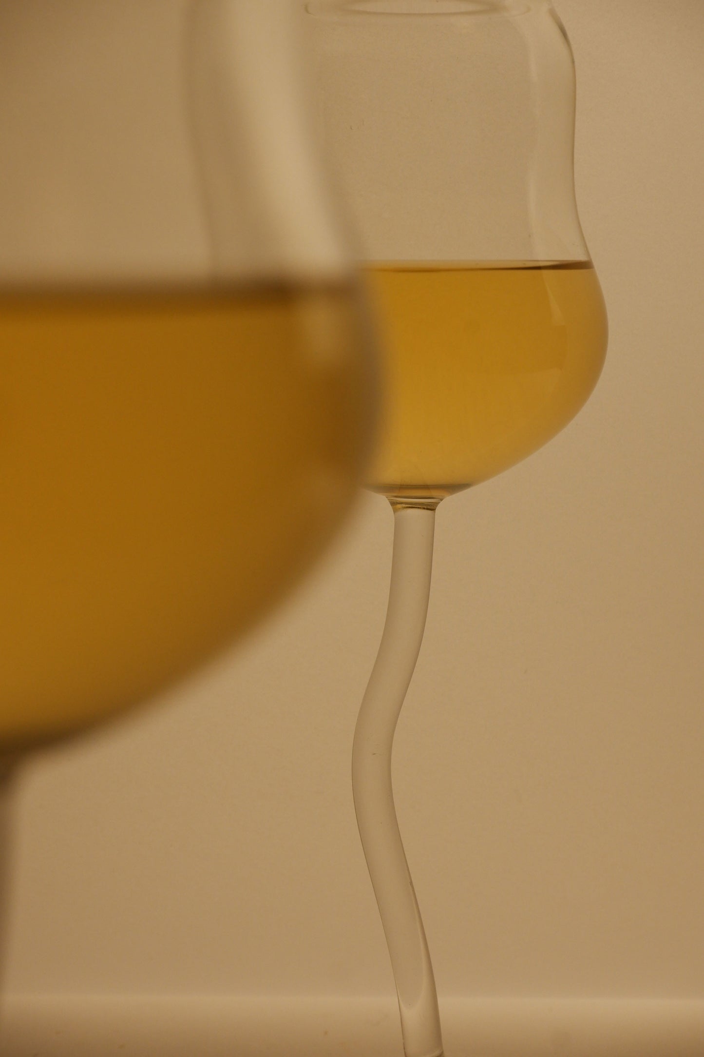 Close-up of a wine glass with a beige background