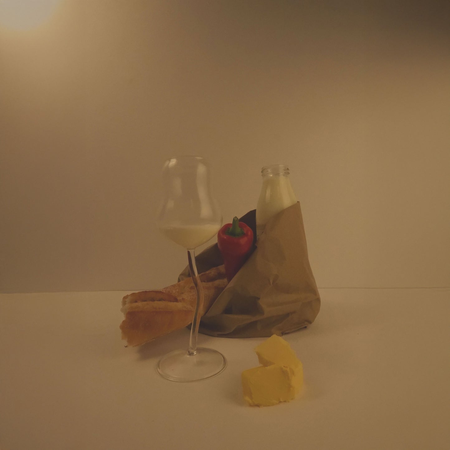 Wine glass, bottle, and food items on a neutral background
