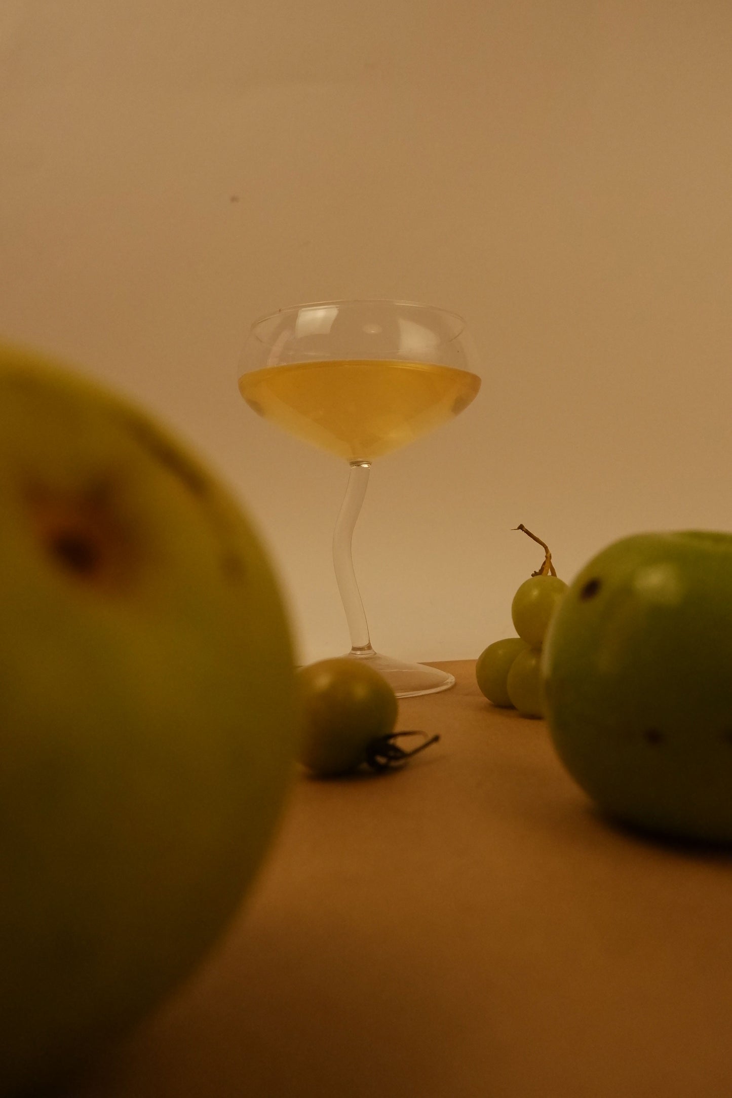 Glass of white wine with green apples on a table