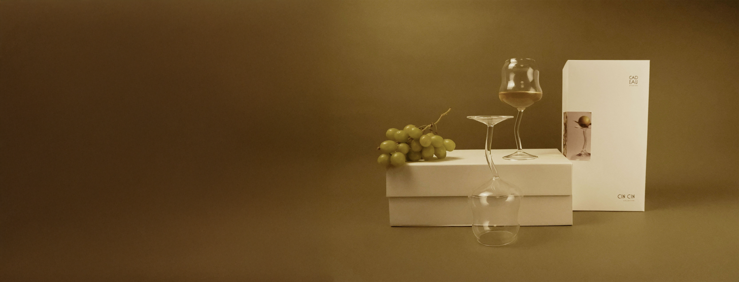 Wine glass, grapes, and a box on a brown background