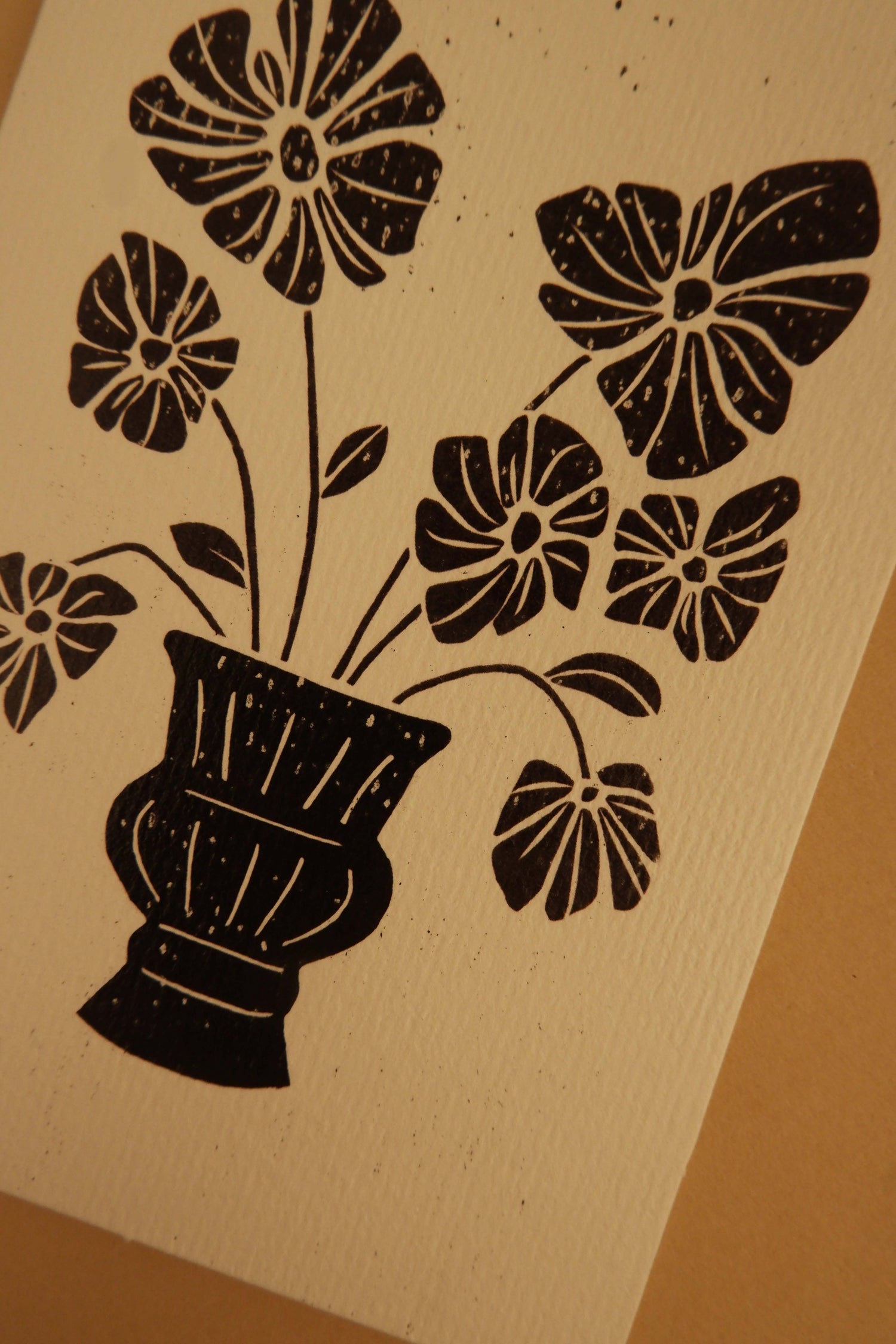 Black floral design on a beige background