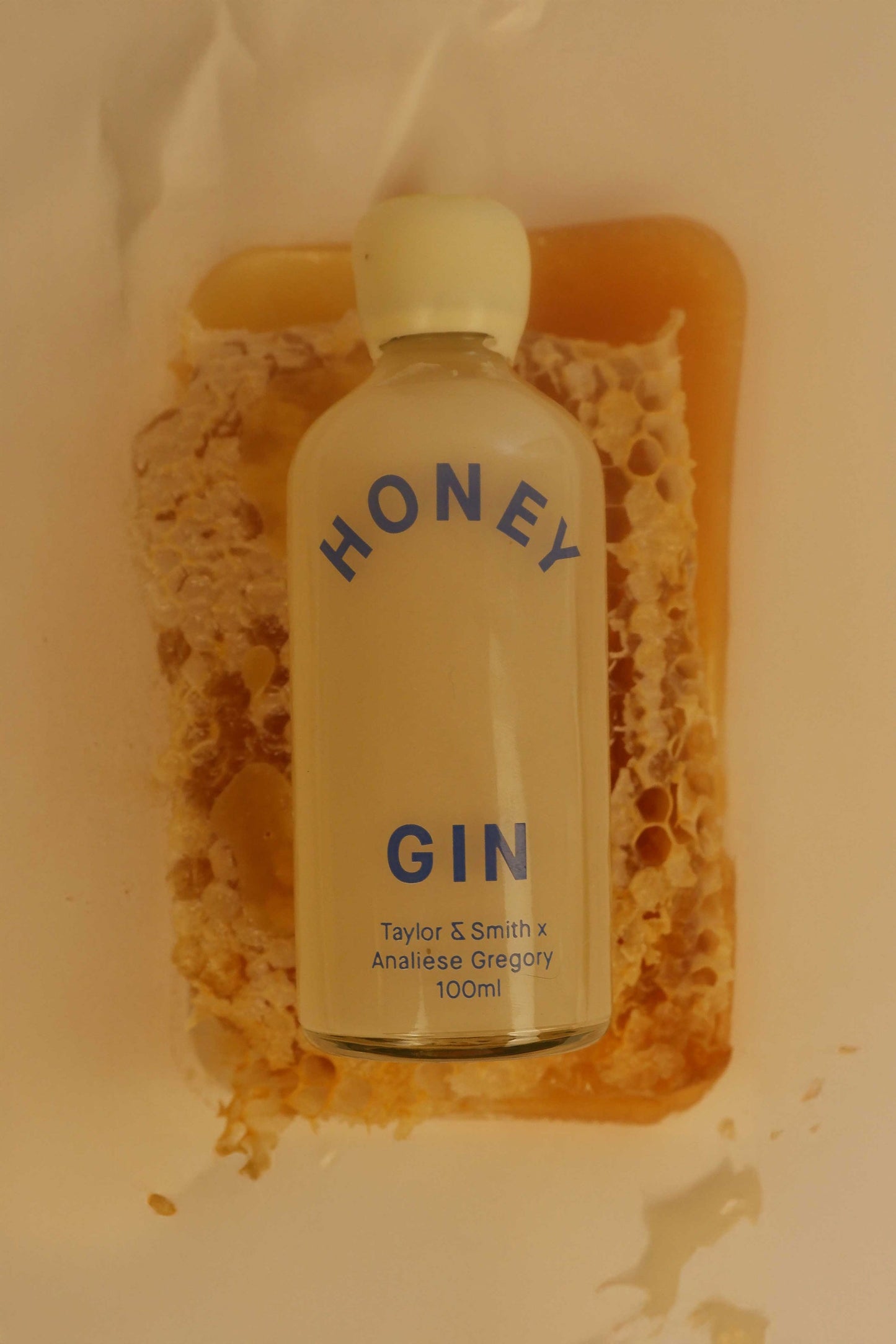 Bottle of honey gin on a honeycomb background