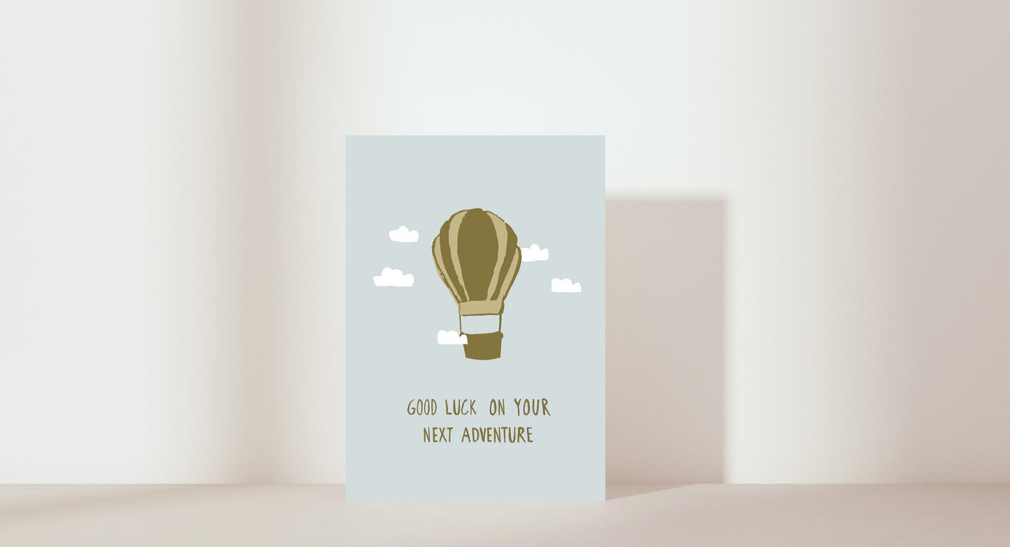 'Good luck on your next adventure' card. Hot air balloon. Colour: green & blue 
