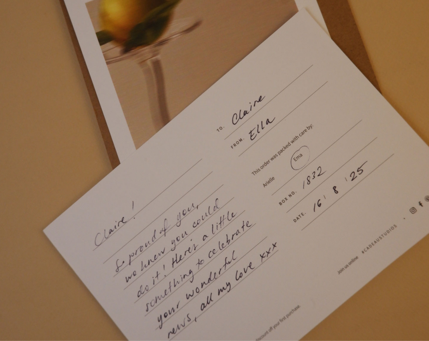 Invitation card with handwritten text on a wooden surface