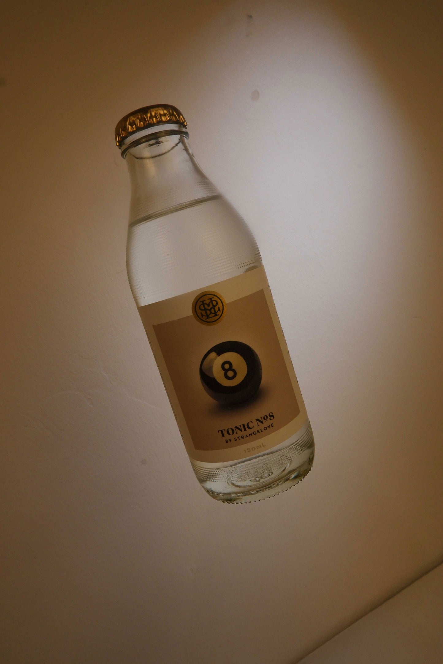 Bottle of Tonic No. 8 with a gold cap on a light background